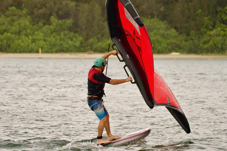 Student wing foiling on a SUP